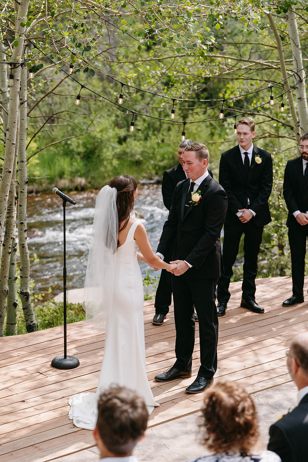 Jason and Amy kissing on the rocks framed by aspen trees